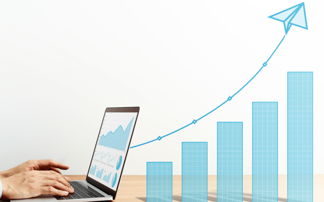 Planning for business growth blog: an image of a person's desk and laptop with a upward moving graph