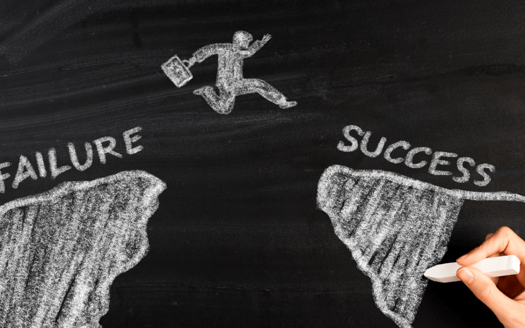 How to deal with failure in business: an image of a blackboard and a drawing of a businessman jumping from one rock to another. The first rock says failure and the second, success.