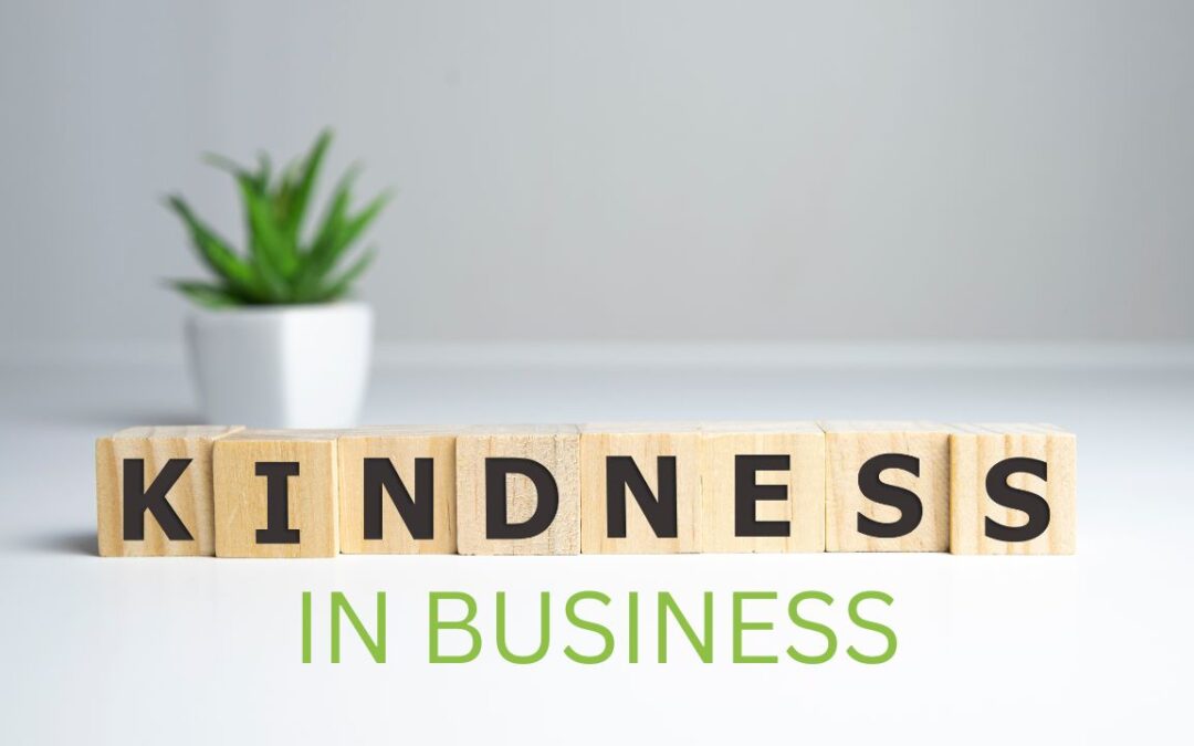 A white office space. Wooden blocks in the foreground. Kindness in business written on them.