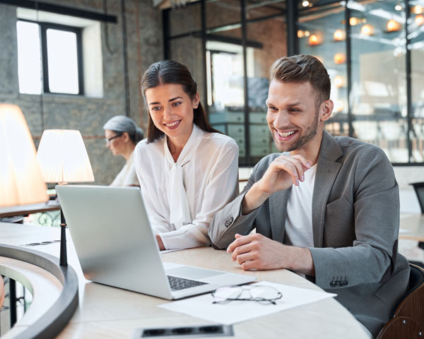 Two managers at a desk with laptop