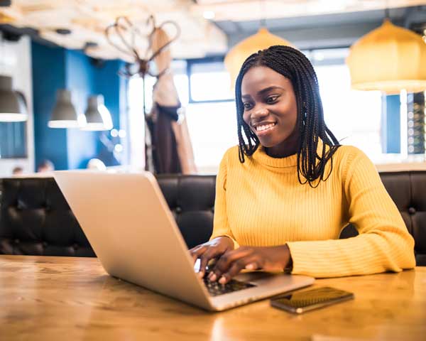 Woman on laptop using profit calculator
