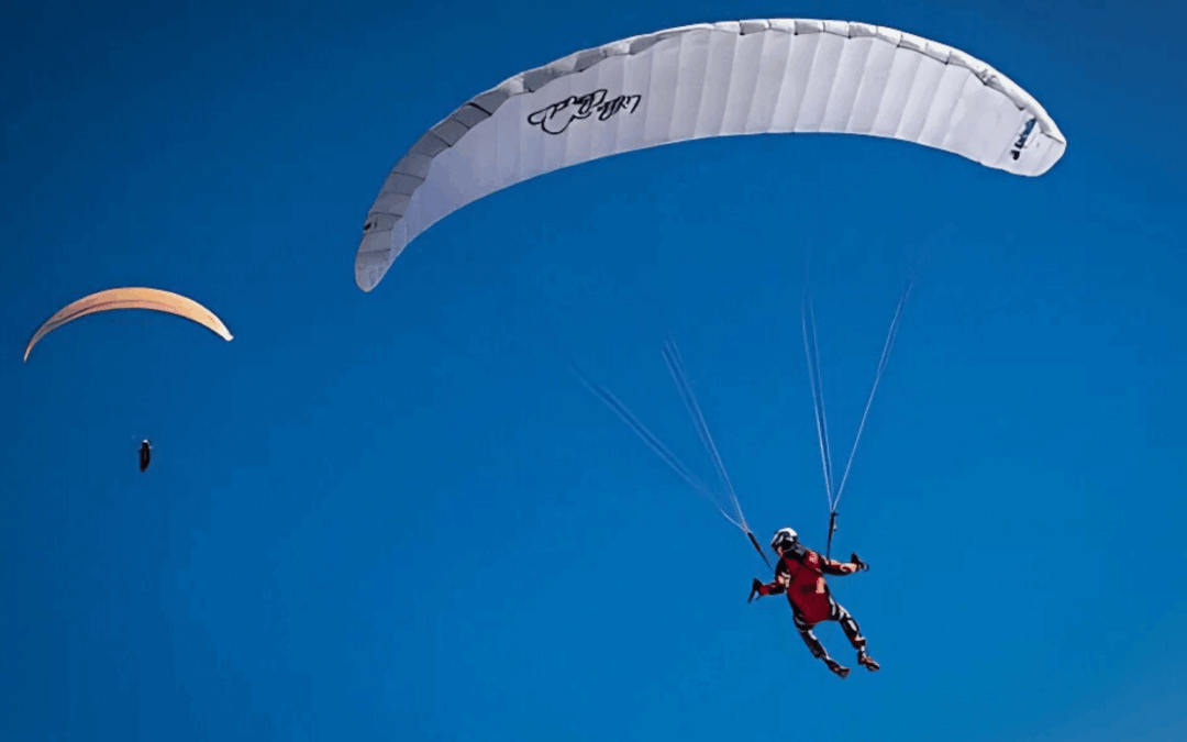 Blog - Travel expenses HMRC allows: a picture of two parachutes against a bright blue sky.