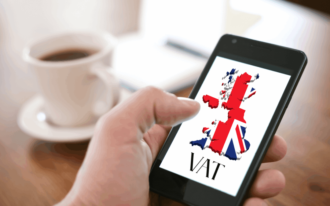 Blog VAT for UK businesses - a close-up image of a person holding a mobile phone. A map of the UK with the flag is on the smartphone screen.